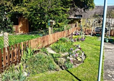 Boundary fencing installed along planted garden beds