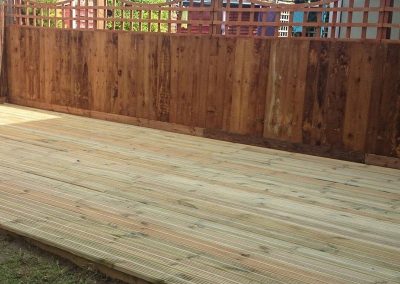 Freshly installed decking boards in residential garden