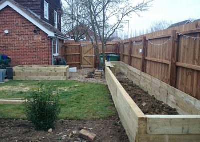 Side pathway secured with tall timber fencing