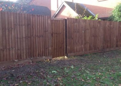 Double wooden driveway gates with matching fence panels